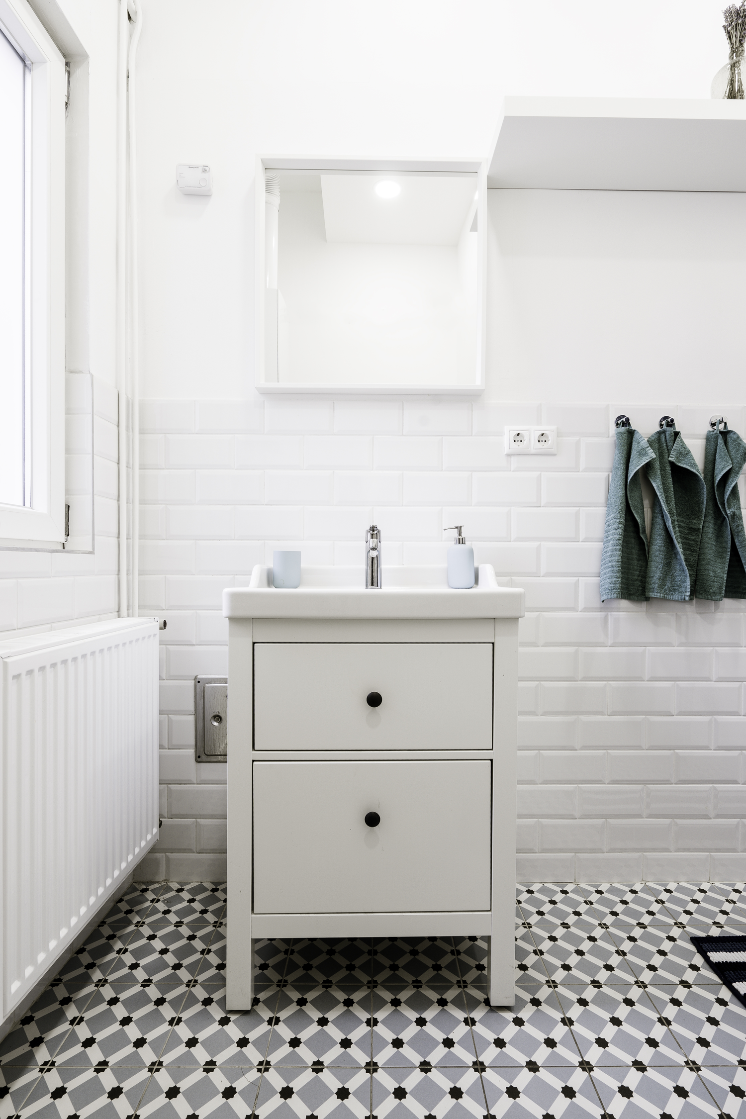 Close-up of a modern sink with chrome hardware and a natural stone bowl.