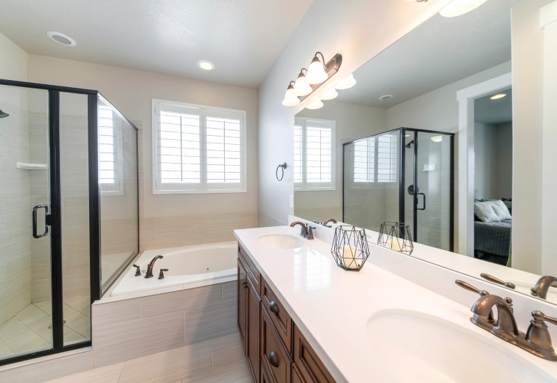 Modern bathroom featuring a double sink, spacious shower space, and a bathtub in Weymouth, MA 