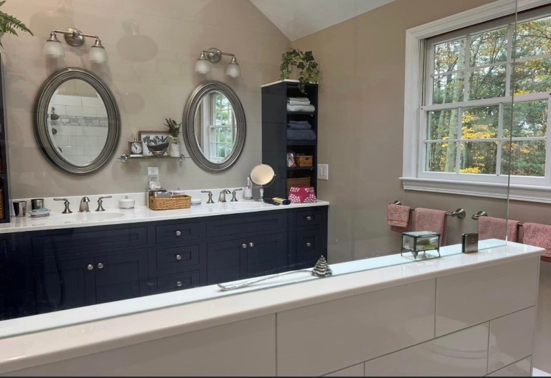 A remodeled bathroom displaying two sinks and mirrors above them in Peabody, MA